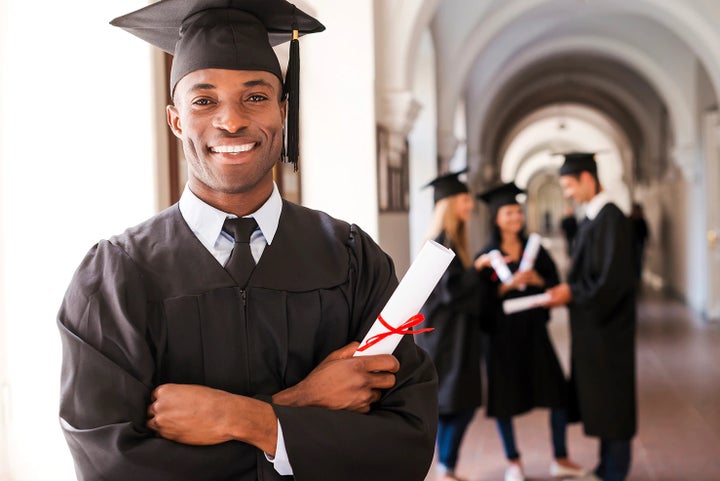 college graduate holding his diploma | Fuccillo Subaru in Watertown NY
