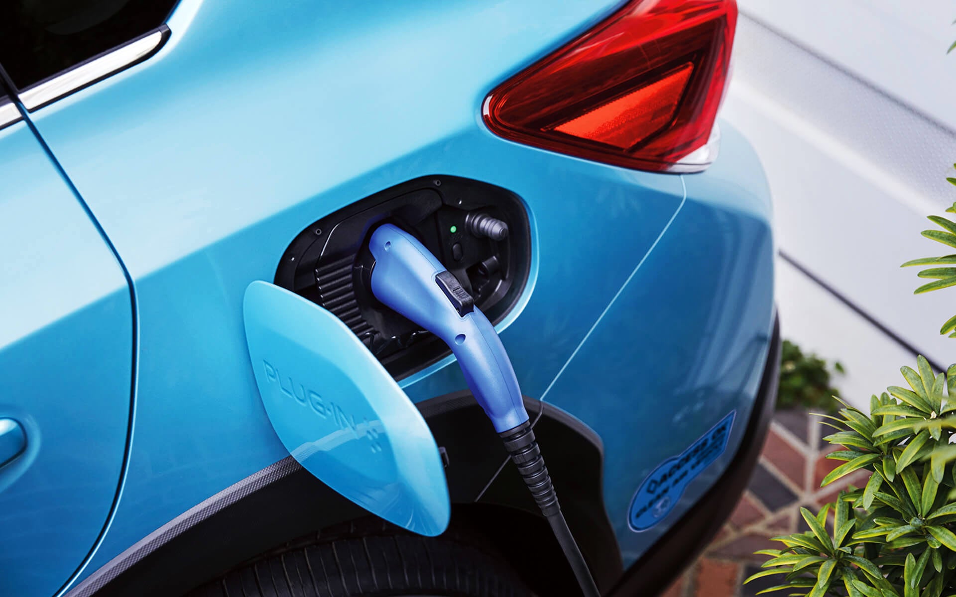 A close-up of the Subaru Crosstrek Hybrid's charging port with charging cable plugged in | Fuccillo Subaru in Watertown NY