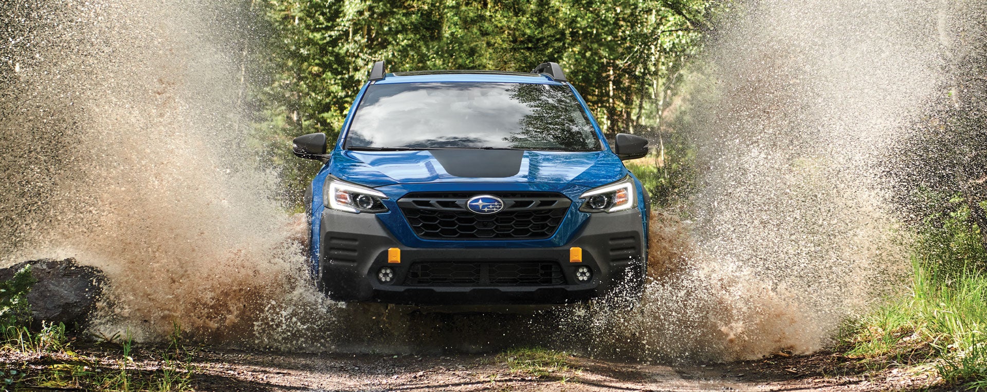A 2023 Outback Wilderness driving on a muddy trail. | Fuccillo Subaru in Watertown NY